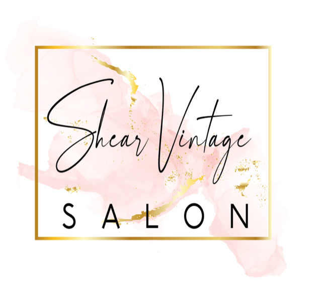 Logo for Shear Vintage Salon with elegant black script and block lettering, set against a pink watercolor background with gold accents and a gold rectangular border.