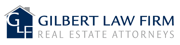 Logo for Gilbert Law Firm with a house icon containing the initials GLF and the text GILBERT LAW FIRM in blue, followed by REAL ESTATE ATTORNEYS in gray below.